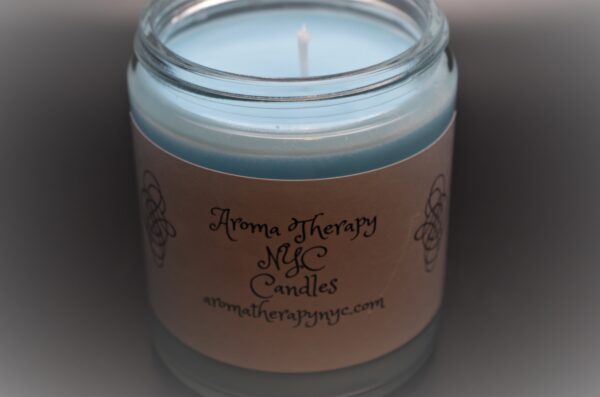 A Burning Flame Light Blue Color Candle on a Glass Jar