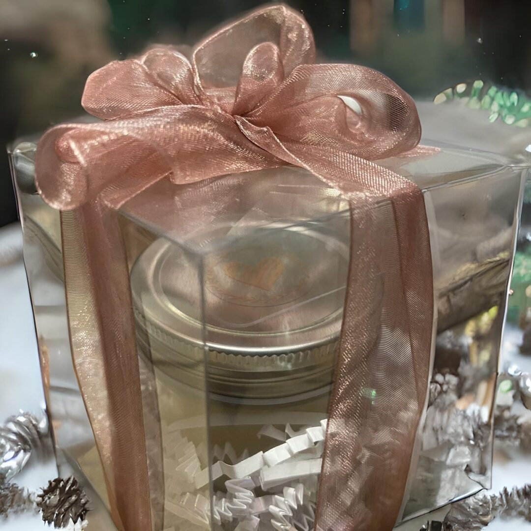 A Jar packed inside a gift box with a ribbon